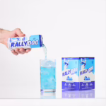 A hand pouring Rally Dog Berry Breeze Vodka Ade into a glass